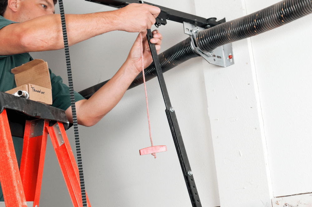 A man repairs a garage door, focusing on a broken spring mechanism.